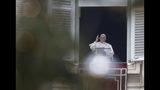 Framed by a Christmas tree, Pope Francis blesses the crowd as he recites the Angelus noon prayer from the window of his studio overlooking St.Peter's Square, at the Vatican, Sunday, Jan. 13, 2019. (AP Photo/Alessandra Tarantino)