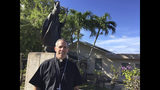 FILE - In this March 3, 2017 file photo, Monsignor Michael Byrnes poses for a photo in front of his residence in Hagatna, Guam. The Vatican officially named Byrnes as Guam's archbishop on Saturday, April 6, 2019, following the definitive sex abuse verdict against his predecessor. (AP Photo/Grace Garces Bordallo, File)